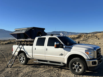 Jiadrooe Titan Series roof top tent on a Toyota Tacoma bed rack setup.